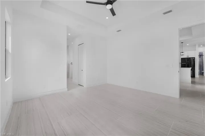 Unfurnished master bedroom with ceiling fan and recessed lighting