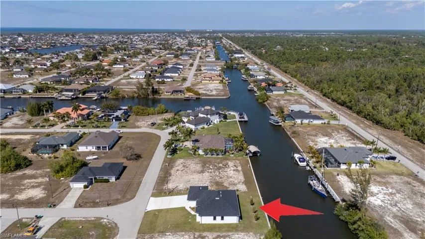 Aerial view of property's location featuring nearby suburban area