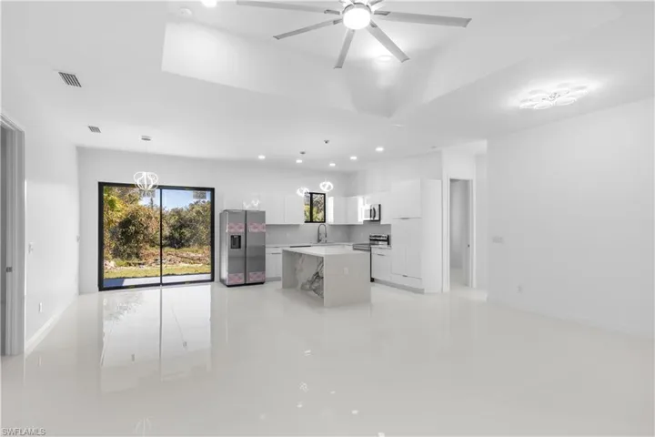Kitchen featuring appliances with stainless steel finishes, white cabinetry, pendant lighting, modern cabinets, and recessed lighting