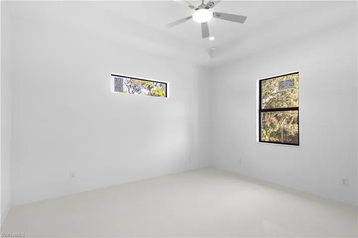 Empty room featuring healthy amount of natural light, ceiling fan, and recessed lighting