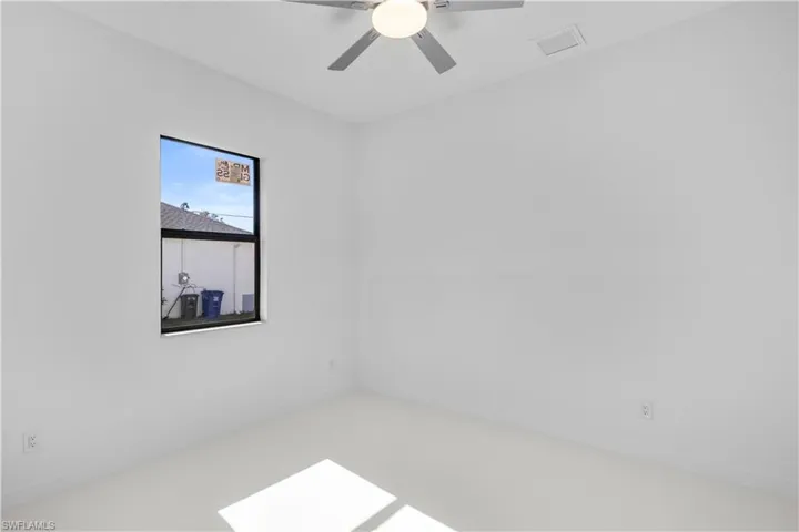 Empty room featuring ceiling fan