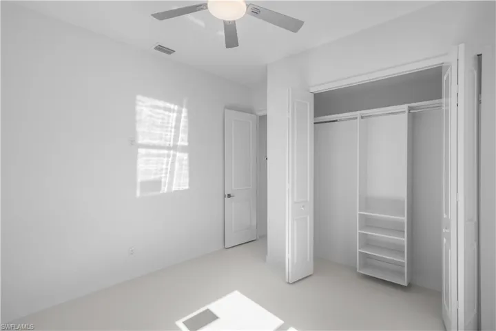 Unfurnished bedroom with concrete floors, ceiling fan, and a closet