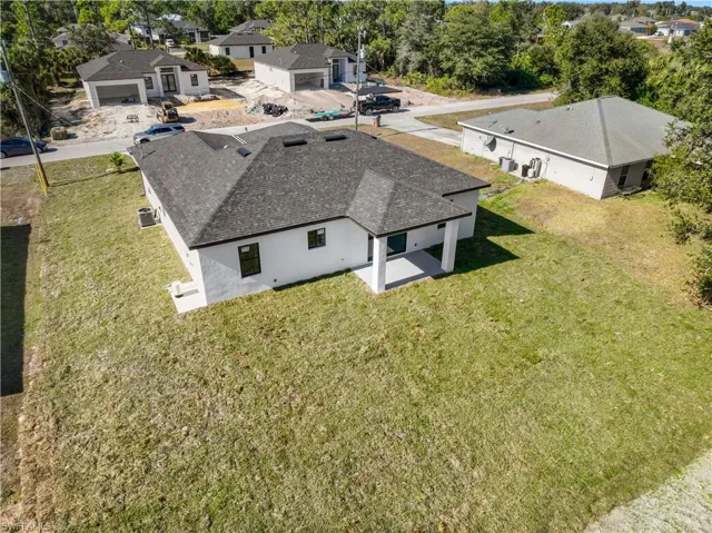 Aerial view of residential area featuring a tree filled landscape