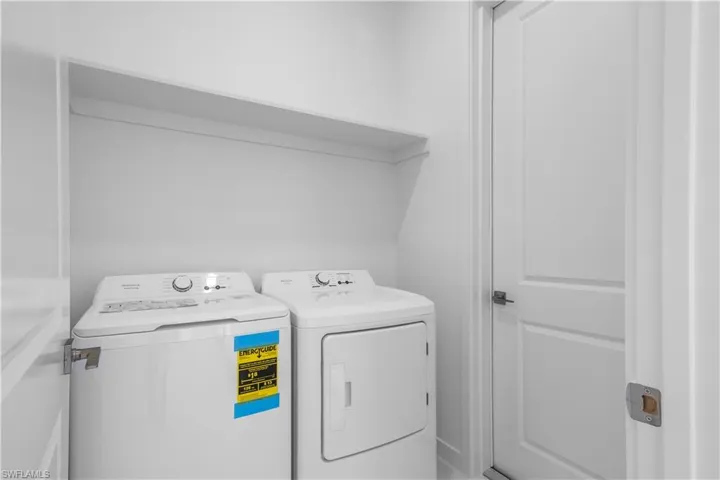 Laundry area featuring washing machine and clothes dryer