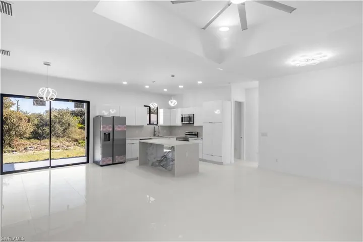 Kitchen with white cabinetry, appliances with stainless steel finishes, hanging light fixtures, recessed lighting, and modern cabinets