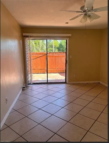 Unfurnished room featuring a ceiling fan and a textured ceiling