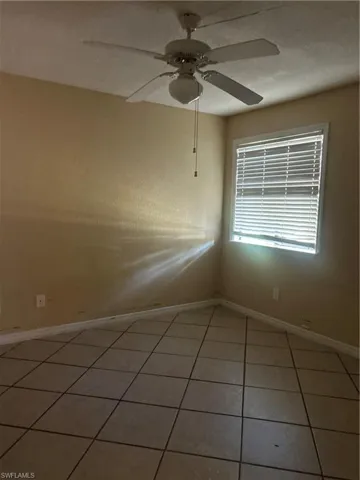 Spare room featuring light tile patterned flooring and a ceiling fan