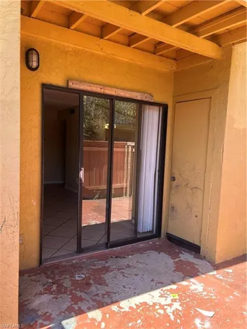 View of exterior entry featuring a patio and stucco siding