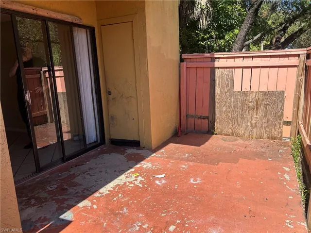 Property entrance with a patio and stucco siding
