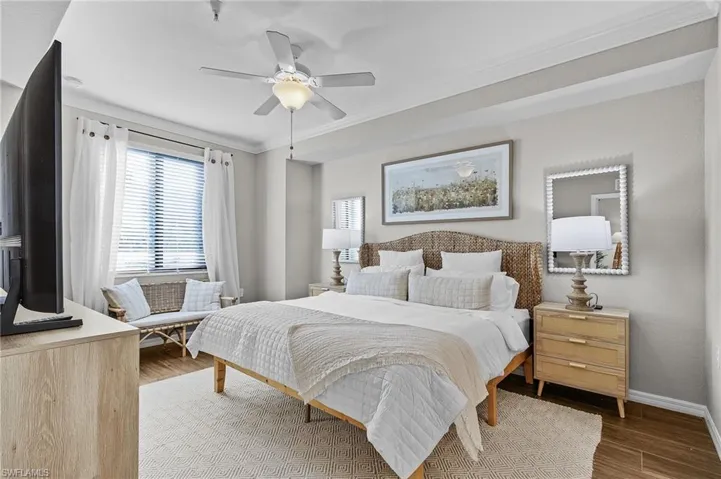 Bedroom featuring ceiling fan, ornamental molding, and hardwood / wood-style flooring