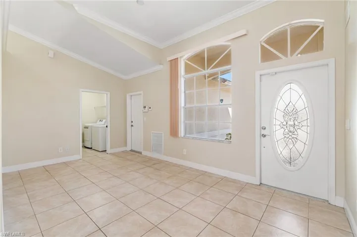 View of front door/entryway. This space could be utilized as several different options: dining rm., family rm., living rm., etc.