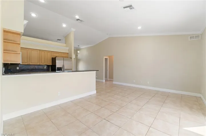 View from family room into kitchen featuring an expansive breakfast bar!