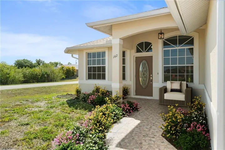 Entryway has been virtually staged to showcase potential landscaping and furniture design. layout.