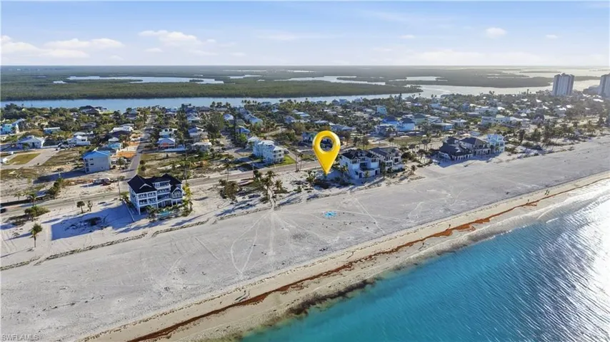 Aerial view of residential area featuring a nearby body of water - Virtually Edited Image