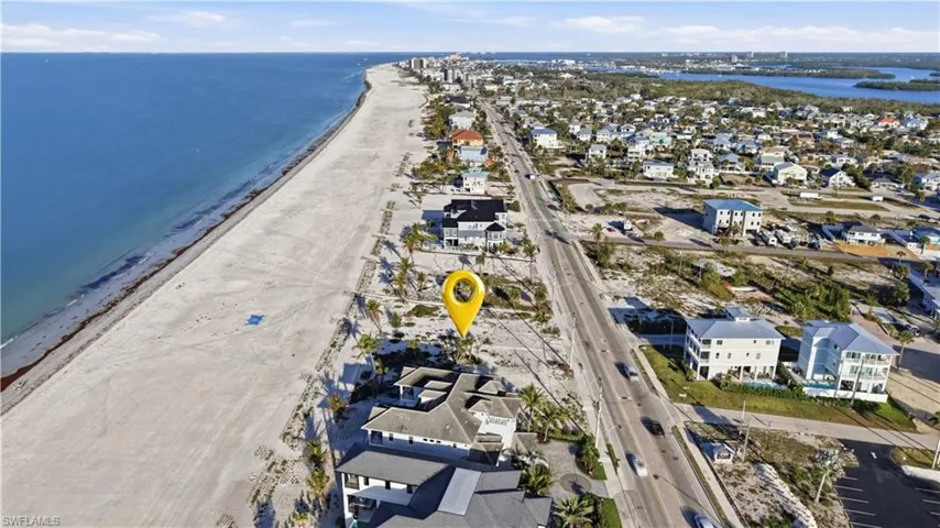 View of property location with nearby suburban area and extended coastline - Virtually Edited Image