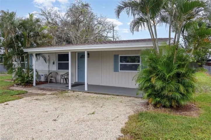 View of front of house featuring a front yard and a porch