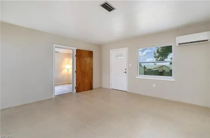 Foyer entrance featuring a wall unit AC