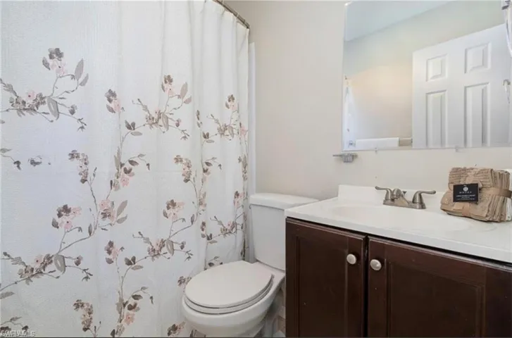 Bathroom with vanity and a shower with shower curtain
