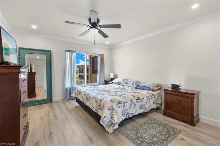 Main Bedroom Suite offers new vinyl flooring, crown & baseboard moldings, new recessed lighting, new paint & two large closets.