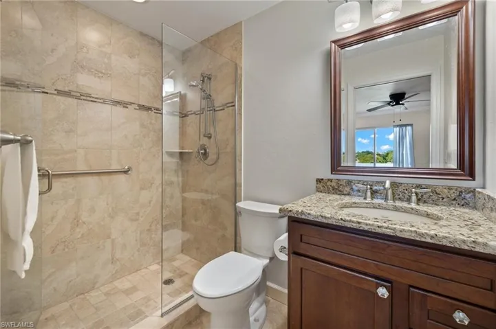 Main Bedroom Updated walk-in tiled shower with frameless glass, new granite high-top vanity with new faucet & lighting