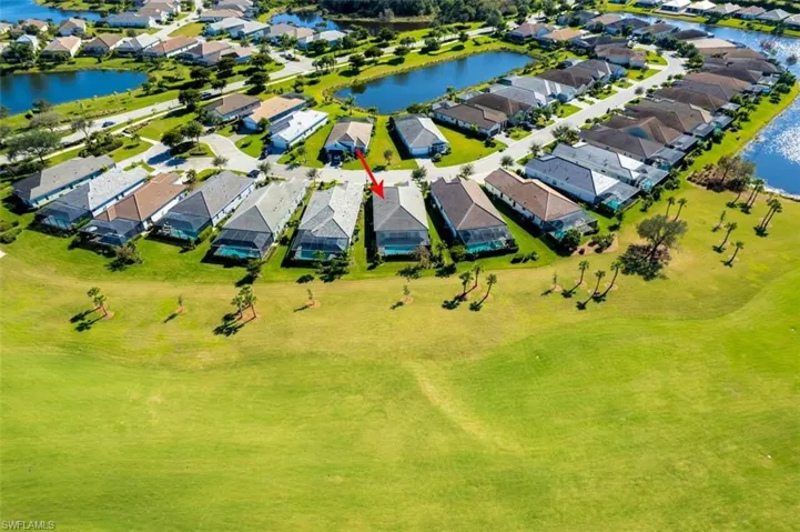 Aerial perspective of suburban area with a nearby body of water