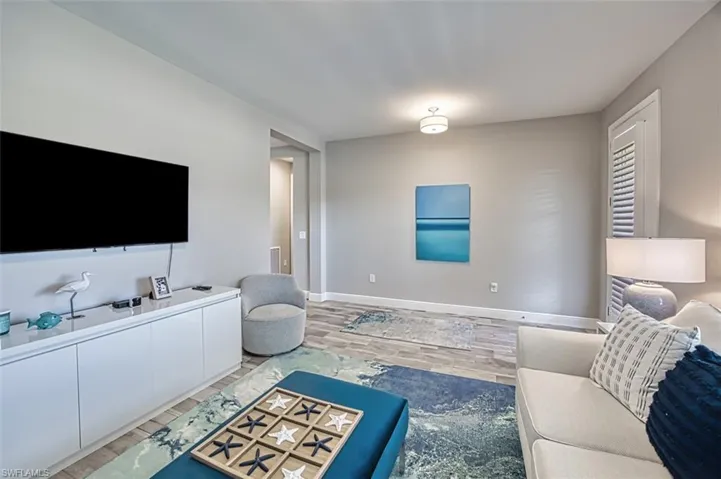 Living area with wood finish floors and baseboards