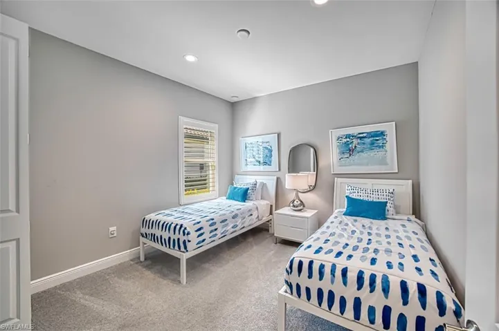 Carpeted bedroom with baseboards and recessed lighting