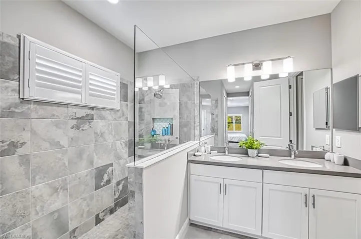 Ensuite bathroom featuring double vanity and walk in shower