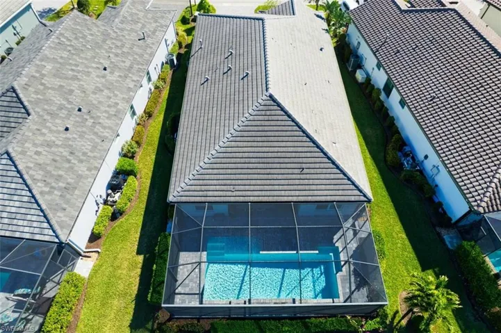 Aerial perspective of suburban area featuring a pool