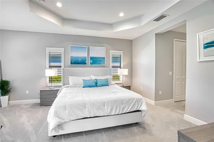 Bedroom featuring a tray ceiling, carpet, and recessed lighting