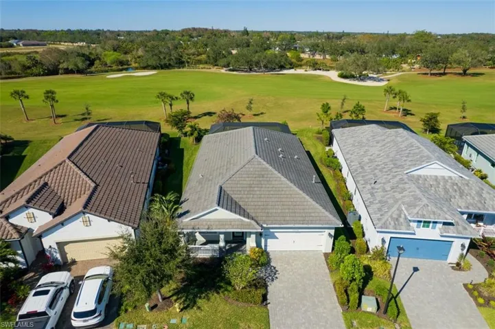 Drone / aerial view of a golf club and a tree filled landscape
