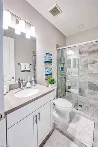 Full bath featuring vanity and a stall shower