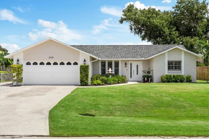Ranch-style home featuring a garage and a front yard
