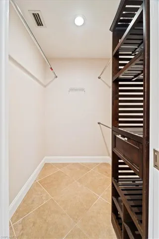 Spacious closet with light tile patterned floors