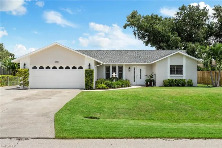Single story home featuring a front lawn and a garage