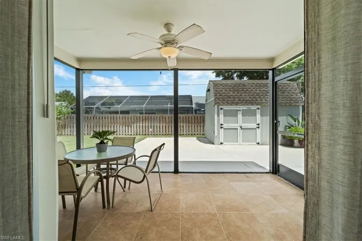 Sunroom / solarium with ceiling fan and a healthy amount of sunlight