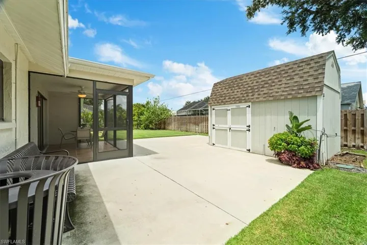 View of patio / terrace with a sunroom and a shed