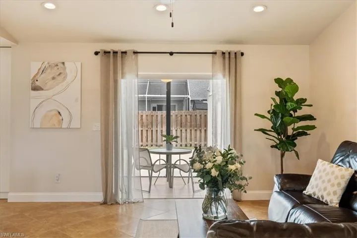 Living area with a healthy amount of sunlight and light tile patterned floors