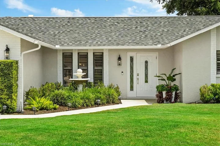 Doorway to property featuring a yard