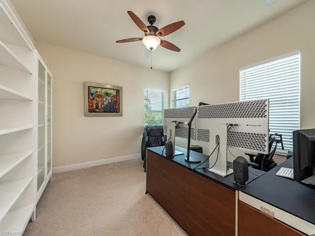 Upstairs Home office with a ceiling fan and light colored carpet