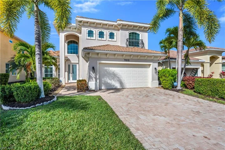 Mediterranean / spanish-style home with stucco siding, decorative driveway, french doors, a tiled roof, and a front yard
