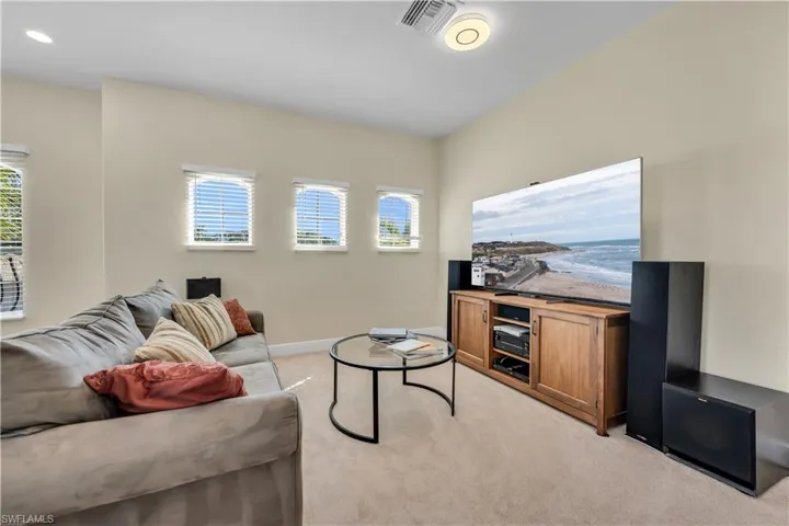 Upstairs Living area featuring light carpet and baseboards