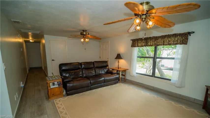 Living room featuring ceiling fan and hardwood / wood-style flooring
