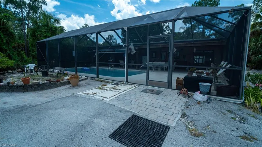 View of patio with a lanai