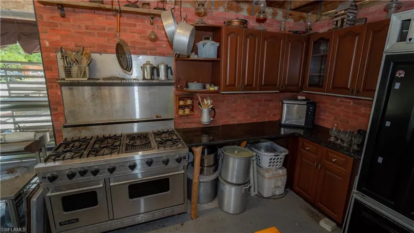 Kitchen featuring double oven range and dark stone countertops