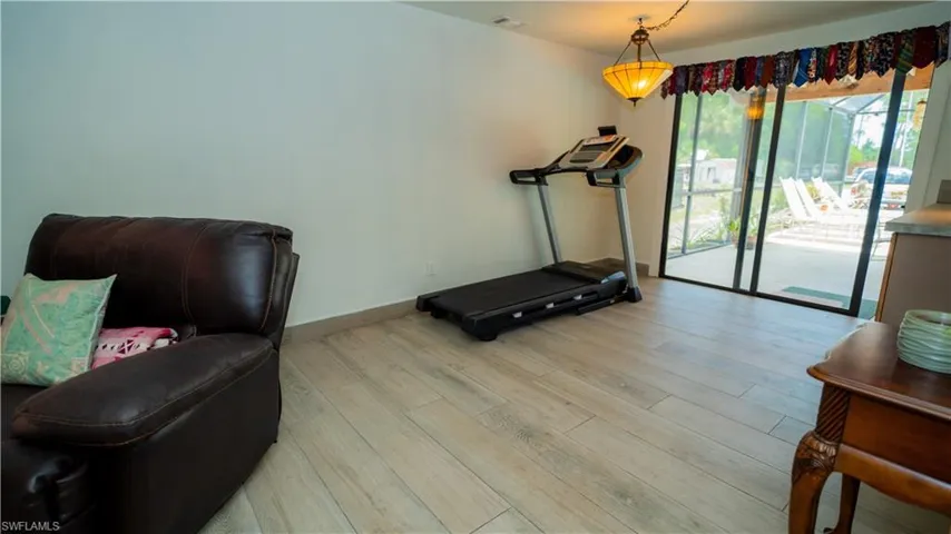 Workout area with light hardwood / wood-style floors