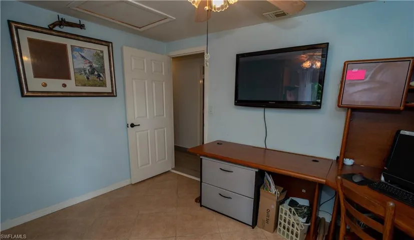 Tiled office featuring ceiling fan