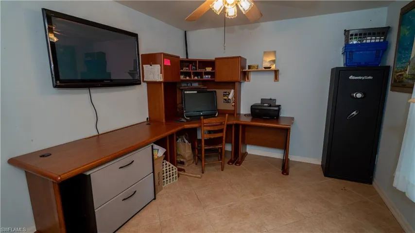 Office featuring ceiling fan and light tile flooring