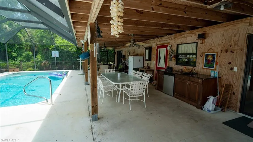View of pool with a patio and a lanai