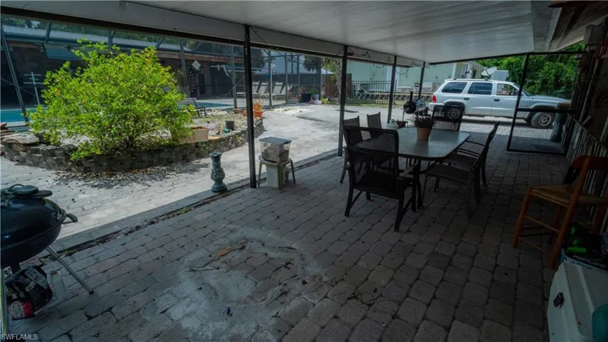 View of patio with a grill